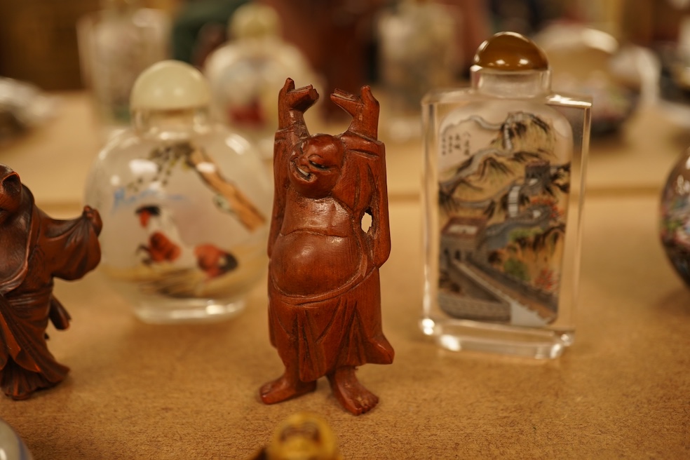 A collection of Chinese and Japanese items comprising snuff bottles, blue and white seal box and netsukes, largest 9cm high